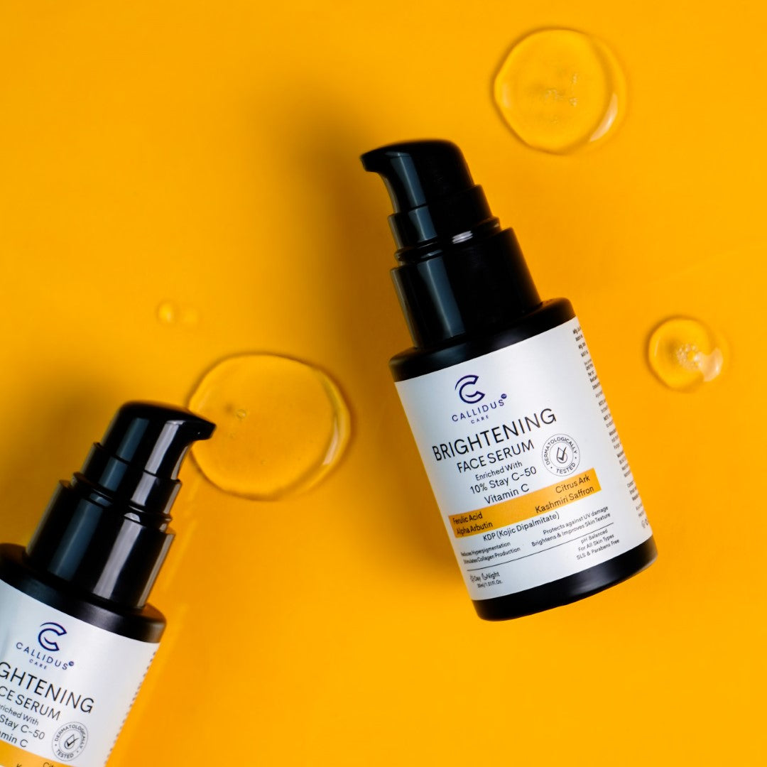 Callidus Care Brightening Face Serum with Vitamin C on vibrant orange background showing serum drops.