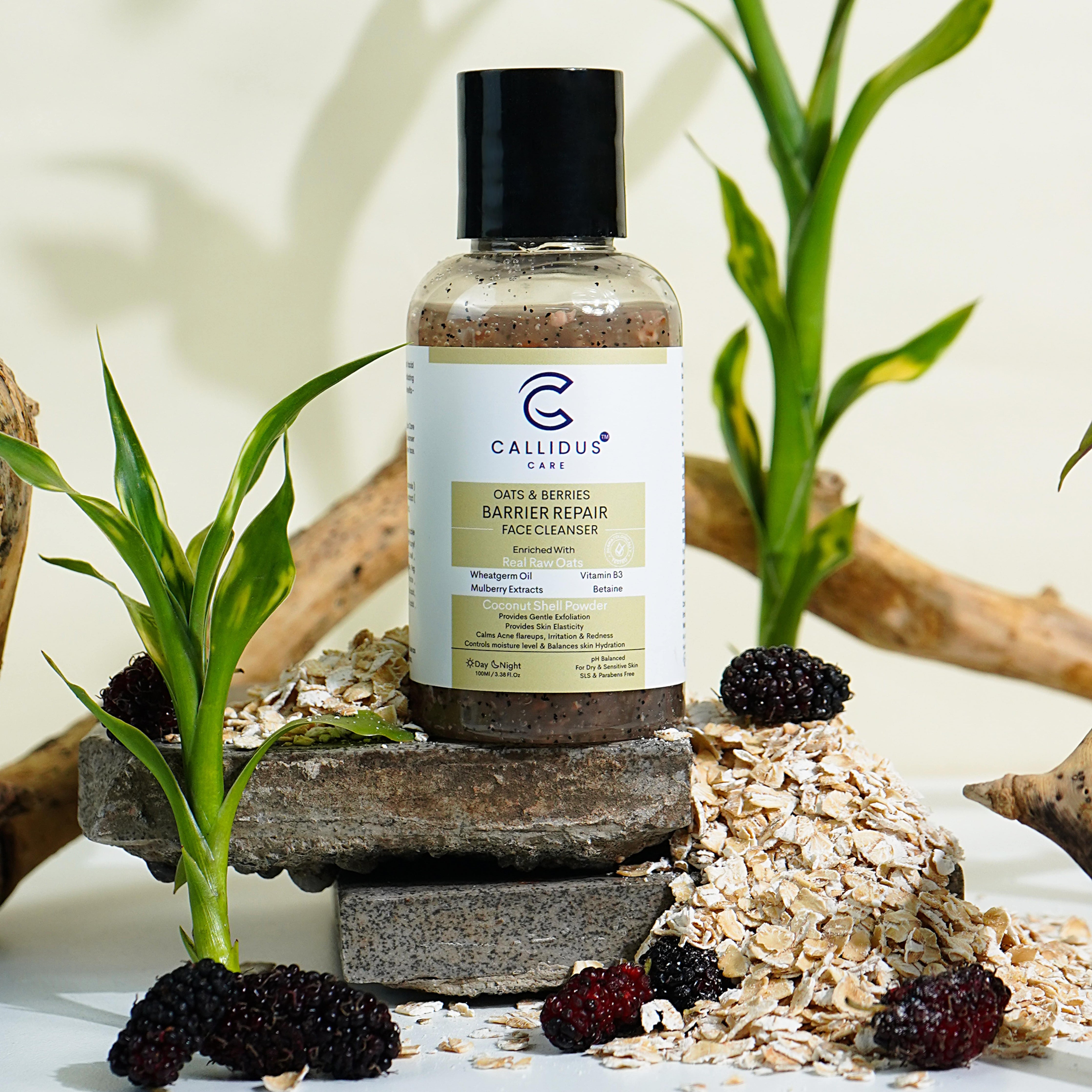 Callidus Care Barrier Repair Face Cleanser with oats and mulberries on a stone setup, showcasing natural ingredients.