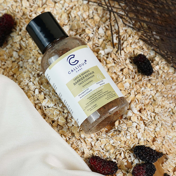 Flatlay of Callidus Care Barrier Repair Cleanser lying on raw oats and berries, highlighting soothing natural elements.